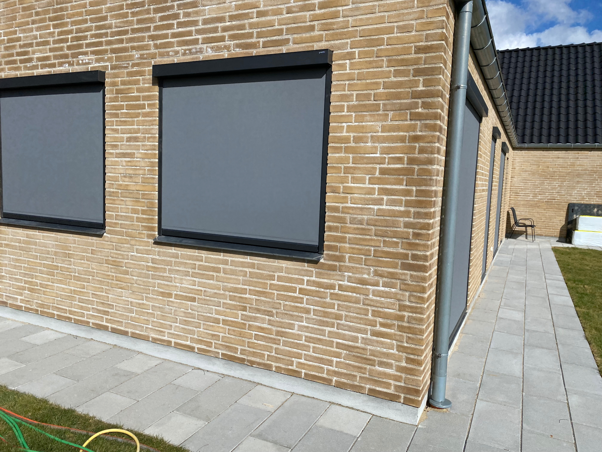 Zip-screens omkring husets hjørne mod terrasse